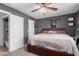 Relaxing main bedroom featuring a ceiling fan, soft carpet, and ample closet space at 4154 W Grovers Ave, Glendale, AZ 85308