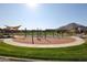 A community playground with climbing structures, set against a scenic mountain backdrop at 4157 W Eli Dr, San Tan Valley, AZ 85144