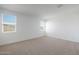 Bright bedroom featuring neutral carpet, two windows for lots of natural light, and neutral walls at 4169 W Eli Dr, San Tan Valley, AZ 85144