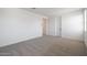 Bright bedroom with carpeted floor, featuring a closet and ample natural light at 4169 W Eli Dr, San Tan Valley, AZ 85144