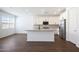 This bright kitchen has white cabinets, stainless appliances, granite countertops, and a kitchen island at 4169 W Eli Dr, San Tan Valley, AZ 85144