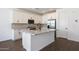 This kitchen has white cabinets, granite countertops, stainless steel appliances, an island, and stylish backsplash at 4169 W Eli Dr, San Tan Valley, AZ 85144