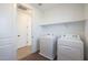 Laundry room includes modern washer and dryer, plus built-in shelving for storage at 4169 W Eli Dr, San Tan Valley, AZ 85144
