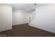 An open-concept living room has plank tile flooring, white walls, a staircase, and is awaiting furniture at 4169 W Eli Dr, San Tan Valley, AZ 85144