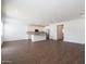 An open floor plan showcases plank tile floors, natural light, and a kitchen featuring a center island at 4169 W Eli Dr, San Tan Valley, AZ 85144