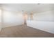 A spacious and naturally lit loft features neutral carpeting and is the perfect blank canvas at 4169 W Eli Dr, San Tan Valley, AZ 85144