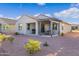 This backyard features a covered patio, a grill, desert landscaping, and outdoor dining set at 42195 W Lavender Dr, Maricopa, AZ 85138