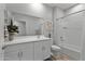 Neutral-toned bathroom with white vanity, chrome fixtures, and shower-tub combo at 42195 W Lavender Dr, Maricopa, AZ 85138