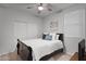 Neutral toned bedroom with a double bed, ceiling fan, and sliding door closet at 42195 W Lavender Dr, Maricopa, AZ 85138