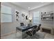 Stylish home office featuring modern desk, comfortable chairs, and ample natural light at 42195 W Lavender Dr, Maricopa, AZ 85138