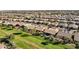 Aerial view of a neighborhood with greenbelts and tile-roofed homes at 42920 W Kingfisher Dr, Maricopa, AZ 85138