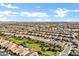 Sprawling aerial view of residential community with green spaces and mountain views at 42920 W Kingfisher Dr, Maricopa, AZ 85138