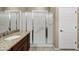 Bathroom featuring a granite countertop, wood cabinets, and a glass-enclosed shower at 42920 W Kingfisher Dr, Maricopa, AZ 85138