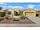 Charming single-story home with desert landscaping, neutral tones and a two car garage at 42920 W Kingfisher Dr, Maricopa, AZ 85138