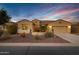 Charming single-story home with desert landscaping, neutral tones and a two car garage at 42920 W Kingfisher Dr, Maricopa, AZ 85138