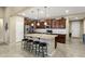 Modern kitchen featuring a center island, stainless steel appliances, and dark wood cabinetry at 42920 W Kingfisher Dr, Maricopa, AZ 85138