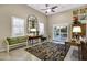 Charming living room with an arched mirror, eclectic furnishings and tile flooring, and neutral paint at 42920 W Kingfisher Dr, Maricopa, AZ 85138