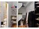 A view from the closet into the bathroom, featuring storage and a shelving unit at 4528 W Valencia Dr, Laveen, AZ 85339