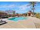 Sparkling community pool with a cabana, surrounded by palm trees, perfect for swimming and relaxing at 4528 W Valencia Dr, Laveen, AZ 85339