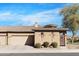 Exterior view of a single-Gathering home with desert landscaping, a tile roof, and a two-car garage at 4528 W Valencia Dr, Laveen, AZ 85339