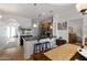 Open kitchen with wood cabinets, granite counters, breakfast bar, and an adjacent dining area, creating a cohesive living space at 4528 W Valencia Dr, Laveen, AZ 85339