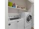 Well-organized laundry room features a modern washer and dryer, complemented by ample shelving for storage at 4528 W Valencia Dr, Laveen, AZ 85339