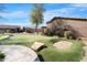 Private putting green with a sand trap, perfect for golf enthusiasts to practice their short game at 4528 W Valencia Dr, Laveen, AZ 85339