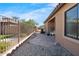 Cozy side yard with desert landscaping, stone tile path, and a wrought-iron fence for privacy at 4528 W Valencia Dr, Laveen, AZ 85339