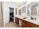 Bright bathroom featuring a vanity with sink and a walk-in closet at 468 E Wolf Hollow Dr, Casa Grande, AZ 85122