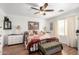 Cozy bedroom with a patchwork quilt, ceiling fan, and white dressers at 468 E Wolf Hollow Dr, Casa Grande, AZ 85122