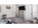 Bright bedroom featuring wood floors, modern dresser, and neutral color scheme at 468 E Wolf Hollow Dr, Casa Grande, AZ 85122