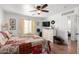 Bedroom with a patchwork quilt, window with blinds, a ceiling fan, and a dresser at 468 E Wolf Hollow Dr, Casa Grande, AZ 85122