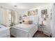 Inviting bedroom with a white bed, decorative pillows, and a bright window at 468 E Wolf Hollow Dr, Casa Grande, AZ 85122