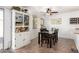 Bright dining room featuring a modern ceiling fan, tile flooring and a built in cabinet at 468 E Wolf Hollow Dr, Casa Grande, AZ 85122