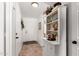 Bright entryway with decor shelves, neutral tile floor, and a white front door at 468 E Wolf Hollow Dr, Casa Grande, AZ 85122