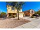 Two-story home with a two-car garage and low-maintenance desert landscaping for easy upkeep at 468 E Wolf Hollow Dr, Casa Grande, AZ 85122