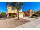 View of the home's front exterior showcasing the driveway and desert landscaping at 468 E Wolf Hollow Dr, Casa Grande, AZ 85122