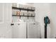 Functional laundry room with washer, dryer, shelving, and storage at 468 E Wolf Hollow Dr, Casa Grande, AZ 85122