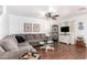 Inviting living room featuring hardwood floors, a comfortable sectional sofa, and neutral walls at 468 E Wolf Hollow Dr, Casa Grande, AZ 85122