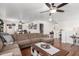 Spacious living room featuring a large sectional sofa, ceiling fan, and hardwood floors at 468 E Wolf Hollow Dr, Casa Grande, AZ 85122