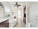 Luxurious bathroom with soaking tub, vanity, dark cabinets, and a walk-in shower at 4926 S Hemet St, Gilbert, AZ 85298