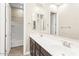 Bathroom showcasing a double sink vanity with dark cabinets, a large mirror, and a separate toilet area at 4926 S Hemet St, Gilbert, AZ 85298