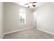 Inviting carpeted bedroom with a ceiling fan and large window for plenty of natural light at 4926 S Hemet St, Gilbert, AZ 85298