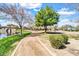 Picturesque community park featuring walking paths, a pond, and basketball court with mature trees at 4926 S Hemet St, Gilbert, AZ 85298