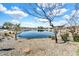 Scenic view of community pond, adorned with natural landscaping under a clear, partly cloudy sky at 4926 S Hemet St, Gilbert, AZ 85298