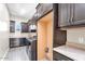 Well-equipped laundry room with washer, dryer, dark cabinets, and ample counter space at 4926 S Hemet St, Gilbert, AZ 85298