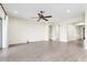 Open-concept living room with neutral paint, ceiling fan, and stylish gray tile flooring at 4926 S Hemet St, Gilbert, AZ 85298