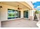 A covered outdoor patio features concrete flooring, sliding glass doors, and a ceiling fan for comfort at 4926 S Hemet St, Gilbert, AZ 85298