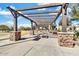 Inviting picnic area with a wooden pergola, stone pillars, and comfortable seating for outdoor gatherings at 4926 S Hemet St, Gilbert, AZ 85298