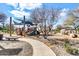 Community playground with covered play area and slide, surrounded by trees and landscaping at 4926 S Hemet St, Gilbert, AZ 85298